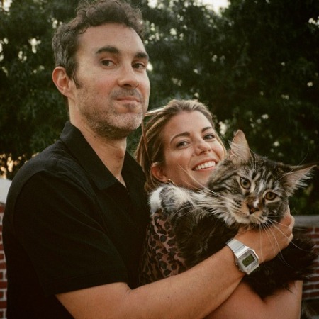 Mae Planert and her husband Mark Normand with their cat Mae Elaine.